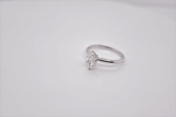 Elegant 14K white gold solitaire ring with a marquise-shaped diamond, measuring 8x4.14 mm and weighing 0.58 carat. Ring size 6 US.