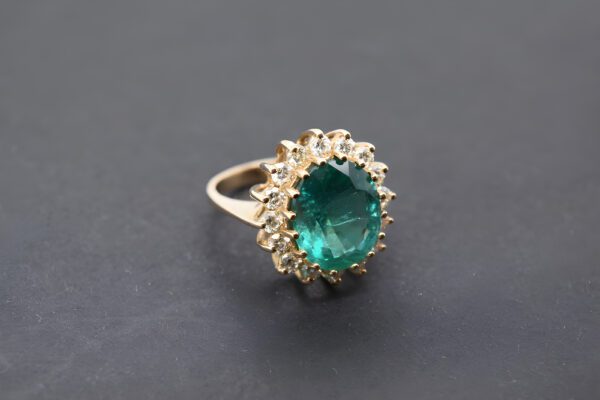 Buy a stunning natural emerald halo engagement ring with diamonds online. This high-quality oval-cut natural emerald halo ring features a 14K gold band and 16 VS1-VS2 diamonds totaling 1.11 carats. The unique design and intricate detailing make it the perfect choice for your engagement ring. Available in size 6, this beautiful emerald and diamond ring is ready to be worn and cherished for a lifetime. Shop now for a gorgeous natural emerald and diamond ring that's sure to be the centerpiece of any collection.