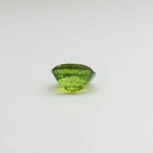 Natural peridot stone oval gemstone, 15.8x13.8x9.1 mm, 14.02 carats. August birthstone known for its positive energy and abundance.