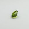 Natural peridot oval gemstone, 15.6x12.9x8.3 mm, 11.86 carats. August birthstone known for positive power and abundance