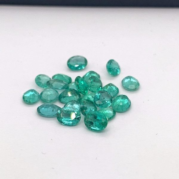 Natural emerald gemstone, oval shape, rich green color with small inclusions. Size 5x4 mm, weight 0.20-0.29 carats. Ideal for earrings, rings, or pendants. Origin: Zambia. May birthstone. Cut and polished in India.