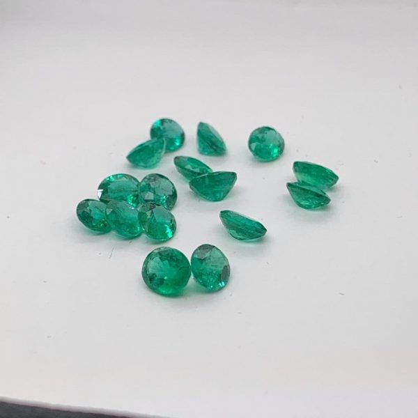 Natural emerald gemstone, oval shape, rich green color with small inclusions. Size 6x5 mm, weight 0.40-0.62 carats. Ideal for earrings, rings, or pendants. Origin: Zambia. May birthstone. Cut and polished in India.